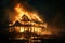 Fire in big wooden house at night, burning building due to wildfire. Single family home in flames and smoke. Concept of damage,