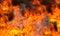 Fire blaze and flame texture background. Fire with black smoke and dust.