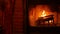 Fire in brick fireplace, firewood burning, wood blazing in cozy lodge or cabin.