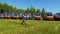 Fire brigade man carries ladder past vehicles on training field