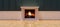 Fire burning in a white classic fireplace, wood floor, wainscot wall, room interior