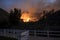 Fire Burns Beyond Neighborhood Park with Fence in Foreground during California Fire