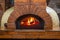 The fire burns in a wood pizza oven