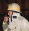 A fire chief talks on a portable radio during a emergency