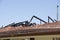 Fire damaged roof of house with chared timber beams