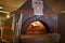 Fire in dome ceramic wood burning pizza oven in the kitchen of A