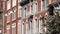 Fire escape ladder outside residential brick building in San Diego city, USA. Typical New York style emergency exit for