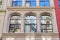 Fire escape reflections in the old stone facade windows in New York