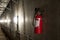 Fire extinguisher in dimly lit corridor