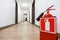 Fire extinguisher in empty business center corridor