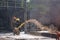 Fire fighter with fire hose at a fire incident, suppressing the blaze