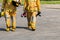 Fire fighter in full gear standing outside a steel building ready to go in