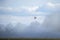 A Fire Fighting Helicopter Amongst The Smoke Cloud Of A Wildfire