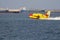 Fire-fighting plane collecting sea water to extinguish a forest fire.