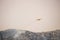 A fire fighting water bomber dropping water on a forest fire on top of the Kozjak mountain in Croatia. Summer wildfires are very