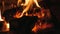 Fire in the fireplace. Firewood, coal, flame. Burning Fireplace - a luminous fire in a stone fireplace to keep warm at
