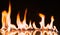 Fire Flames Igniting And Burning.Real fire , A line of real flames ignite on a black background