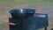 A fire flares up in the brazier and a cauldron lies above it, ready to prepare food for a picnic in nature