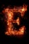 Fire font alphabet E made of burning fire letter on black background