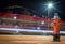 Fire hydrant at night as a fire truck streaks through the background leaving light trail.