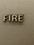 FIRE inscription on a wall background