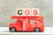 Fire ladder truck hold block in word COS Abbreviation of Cost of sales, Class of service, Cosine on wood background