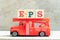 Fire ladder truck hold block in word EPS Abbreviation of Earnings per share on wood background