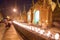 Fire lit up for prayer at Crowded & Shwedagon Pagoda in the evening during sunset