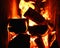 Fire. Photo of flames devouring firewood in a stone fireplace. The texture of the fire in the fireplace. Burning wood inside