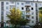 Fire in a residential, apartment building. Opened, broken windows of a burnt-out apartment, soot on the facade of the building