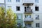 Fire in a residential, apartment building. Opened, broken windows of a burnt-out apartment, soot on the facade of the building