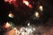 Fire show. Night background. Fireworks. Salute. Holiday of Christmas and New Year in bright falling stars with scarlet and blue