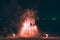 Fire steel wool with water reflection on sea in beach club party at night Samui Thailand