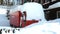 Fire truck covered with a snowdrift after a cold winter night.