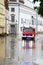 Fire truck drives through the flooded streets of the old town of Lubeck to warn residents during high water when the river Trave