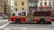 Fire truck with lights and sirens on racing through the streets of New York City on a call.