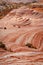 Fire wave with swirly layers of deposited sandstone during wonderful sunny day with blue sky, in Valley of Fire State Park