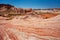 Fire wave with swirly layers of deposited sandstone during wonderful sunny day with blue sky, in Valley of Fire State Park