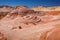 Fire wave with swirly layers of deposited sandstone during wonderful sunny day with blue sky, in Valley of Fire State Park