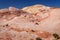 Fire wave with swirly layers of deposited sandstone during wonderful sunny day with blue sky, in Valley of Fire State Park