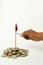 Firecracker rocket on stack of Coins and hands burning the rocket on isolated background with copy space