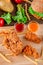Fired chicken and chicken nuggets and spicy drumsticks on wooden background. Set of fired crispy chicken. Crispy fried chicken in
