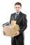A fired man in a suit carrying a box