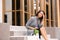 Fired woman with personal stuff sitting on stairs outdoors