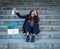 Fired woman on stairs holding face mask. conceptual image of Coronavirus job cuts and unemployment