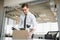 Fired young man packing his stuff in office