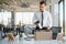 Fired young man packing his stuff in office