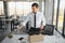 Fired young man packing his stuff in office