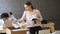 Fired young upset woman packing box standing near work desk