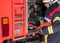 Firefighter in action connected a fire hose on the fire truck